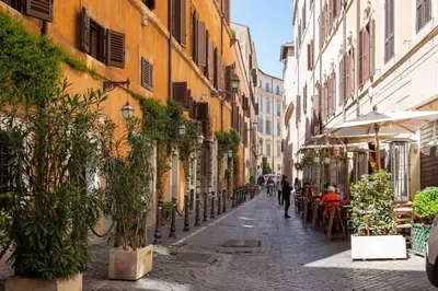 an alley with people walking down a street at Piazza Navona - Tiny House in Rome