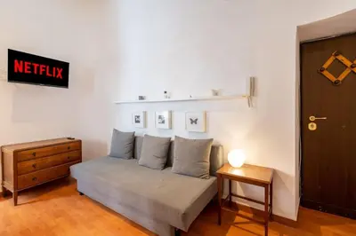a bedroom with a bed with pillows and a table at Piazza Navona - Tiny House in Rome