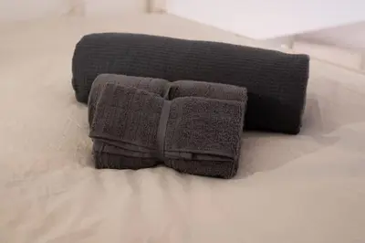a pair of towels sitting on a bed at Piazza Navona - Tiny House in Rome