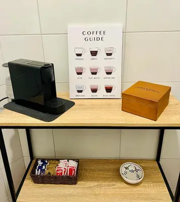 a shelf with a coffee cube and a box on it at Elegant Apartment Villa Bianca in Rome