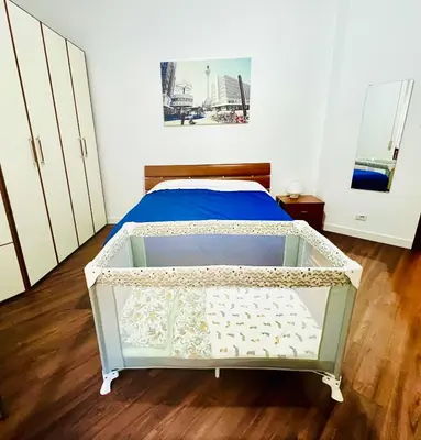 a bedroom with a bed with a wooden floor at Elegant Apartment Villa Bianca in Rome