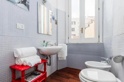 a bathroom with a white toilet and a sink at Colosseum Home-ZENO 32 in Rome