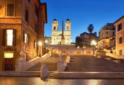 a set of stairs leading to a building with a clock tower at San Vito Suites in Rome