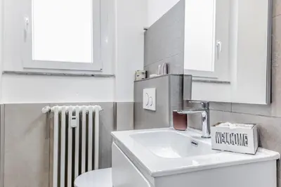 a bathroom with a sink and a mirror and a radiator at Vatican Central Residence in Rome