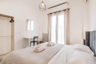 a white bedroom with towels on a bed at Vatican Central Residence in Rome