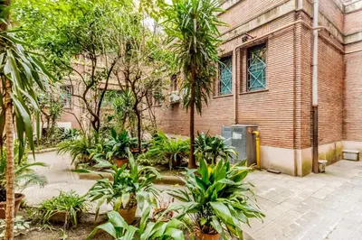 a building with a bunch of plants in front of it at Vatican Central Residence in Rome