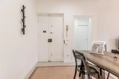 a room with a table and chairs and a door at Vatican Central Residence in Rome
