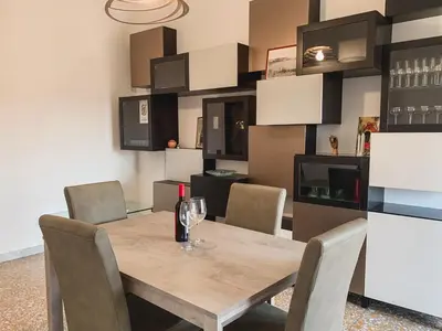 a dining room with a wooden table and chairs at Luminoso non lontano dalla stazione TERMINI in Rome