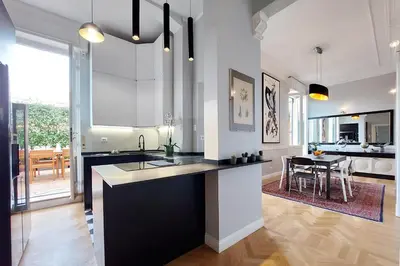 a kitchen with a black and white counter top at LuxuryTerrace RomeApartment in Rome
