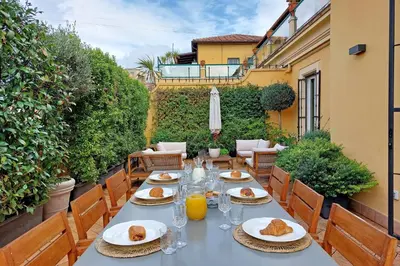 a table with plates of food on a patio at LuxuryTerrace RomeApartment in Rome
