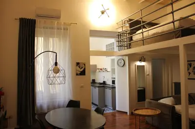 a living room with a loft bed and a table at AD HOMES - Saint Peter Loft in Rome