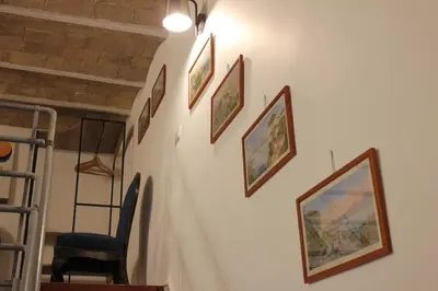 a hallway with framed pictures on a wall at AD HOMES - Saint Peter Loft in Rome