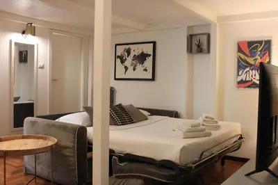 a bedroom with a bed and a table in a room at AD HOMES - Saint Peter Loft in Rome