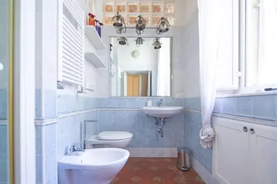 a bathroom with a sink and a toilet and a mirror at Suite Valeria in Rome