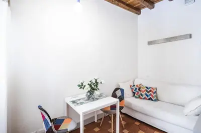 a living room with a white couch and a table at Suite Valeria in Rome