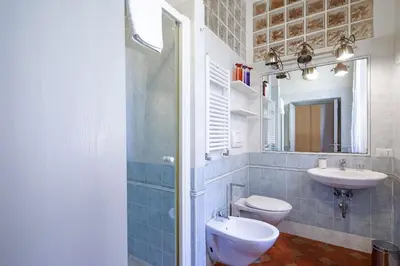 a bathroom with a sink and a toilet and a mirror at Suite Valeria in Rome