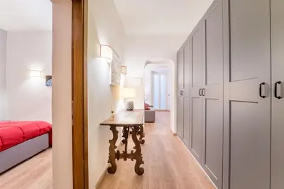 a bedroom with a table and a bed and a hallway at Atelier dello Statuto, a few steps from Colosseo in Rome
