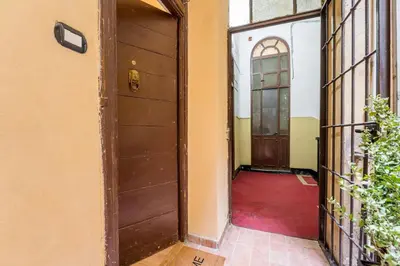 an entrance to a house with a wooden door at Atelier dello Statuto, a few steps from Colosseo in Rome