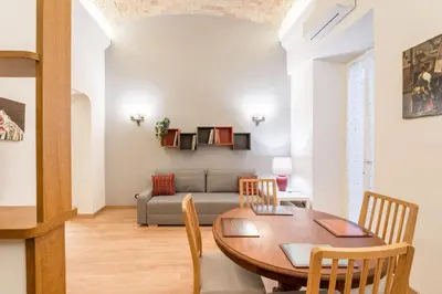 a living room with a table and a couch at Atelier dello Statuto, a few steps from Colosseo in Rome