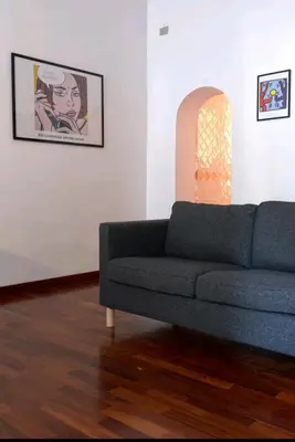 a living room with a blue couch and a picture at Grazioso appartamento ai Musei Vaticani in Rome