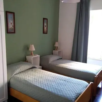 a room with two beds and a window at Grazioso appartamento ai Musei Vaticani in Rome