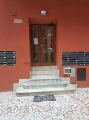 a red building with stairs in front of a door at Grazioso appartamento ai Musei Vaticani in Rome