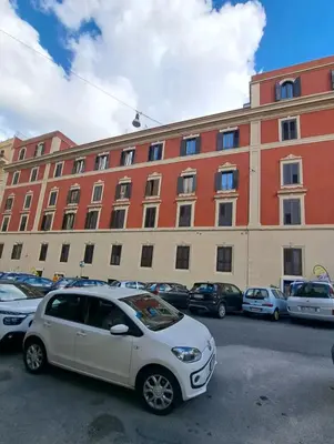 a white car parked in front of a large building at Grazioso appartamento ai Musei Vaticani in Rome
