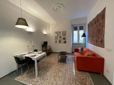 a living room with a red couch and a table at Cozy apartment near the Colosseum in Rome