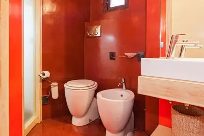 a bathroom with a white toilet and a sink at Suite San Calisto Trastevere - by romanhouseit in Rome
