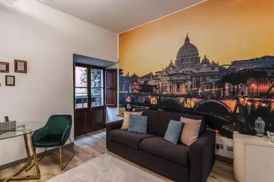 a living room with a couch and a painting of the city at Suite San Calisto Trastevere - by romanhouseit in Rome