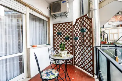 a balcony with a table and two chairs and a window at San Pietro Intero Alloggio -PANE&MELE- in Rome