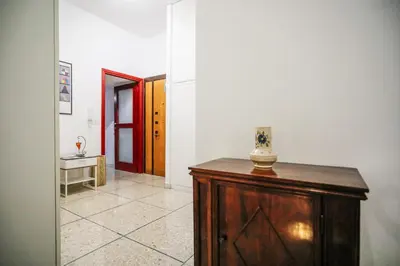 a hallway with a wooden cabinet in a room at San Pietro Intero Alloggio -PANE&MELE- in Rome
