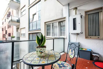 a balcony with a table and two chairs and a plant at San Pietro Intero Alloggio -PANE&MELE- in Rome