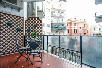 two chairs on a balcony with a view of a city at San Pietro Intero Alloggio -PANE&MELE- in Rome