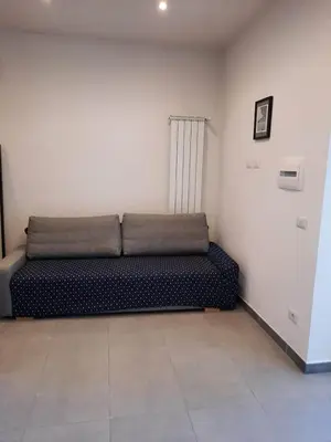 a black couch sitting in a room at Il giardino di Marimar in Rome