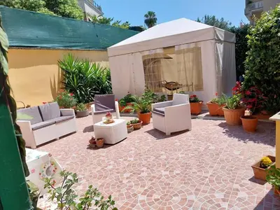 a patio with chairs and a tent with plants at Il giardino di Marimar in Rome