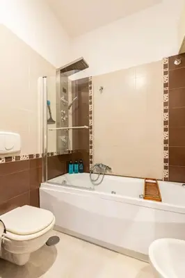 a bathroom with a tub and a toilet and a sink at La Casudda di Ro' - metro A Battistini in Rome