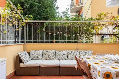 a couch on a balcony with a table at La Casudda di Ro' - metro A Battistini in Rome