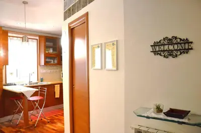 a room with a kitchen with a table and a counter at La Casudda di Ro' - metro A Battistini in Rome