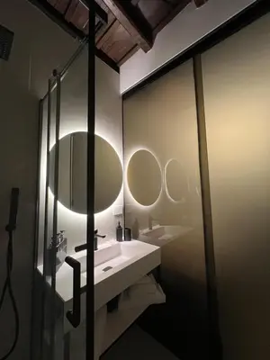 a bathroom with a sink and two mirrors at Affreschi al Pantheon in Rome
