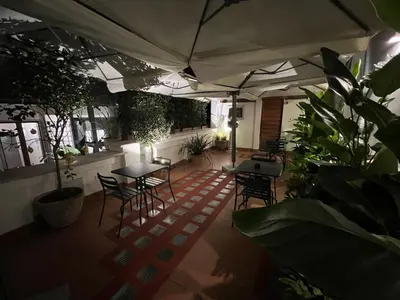an outdoor patio with tables and chairs and plants at Affreschi al Pantheon in Rome