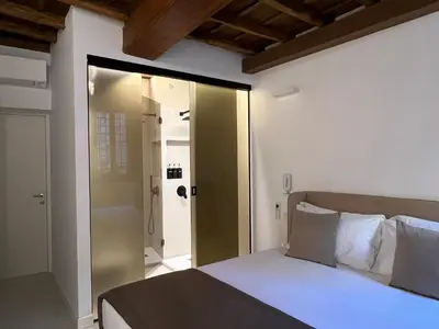 a bedroom with a bed and a sliding glass door at Affreschi al Pantheon in Rome