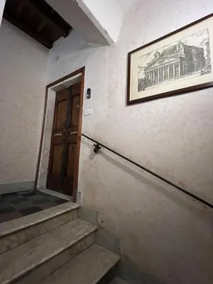a staircase with a door and a picture on the wall at Affreschi al Pantheon in Rome