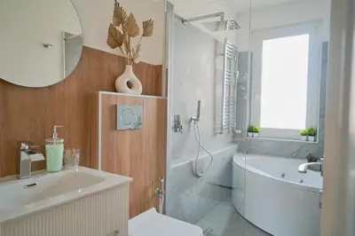 a bathroom with a tub and a toilet and a sink at Basilica San Paolo - Home Cinema e Vasca Idromassaggio in Rome