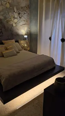 a bedroom with a large bed with white curtains at Rome Elements Apartment in Rome
