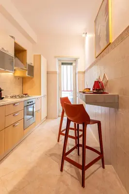 a kitchen with a table and a chair in it at Rome Elements Apartment in Rome