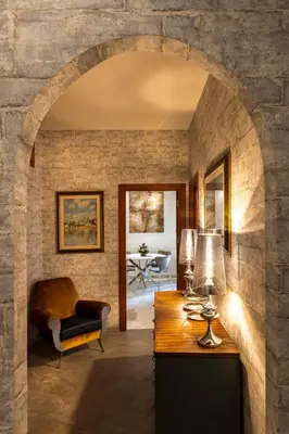 an archway in a room with a table and a chair at Rome Elements Apartment in Rome