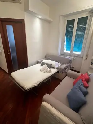 a room with two beds and a couch and windows at Podesti House - Flaminio Stadio Olimpico in Rome