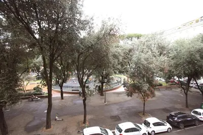 a group of cars parked in a parking lot with trees at Testaccio Holiday House in Rome