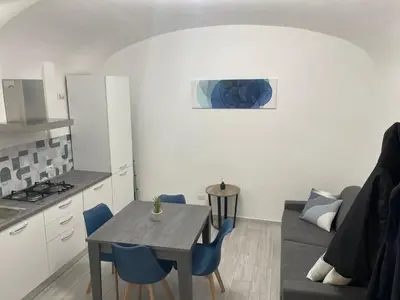 a kitchen and living room with a table and a couch at TrastevereLoft228 Apt. WHITE in Rome